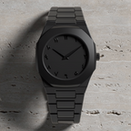 ValoraTime Maktub watch lifestyle photograph on a light gray travertine surface.