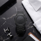 ValoraTime Pure watch lifestyle photograph on a gray linen surface, alternate composition.